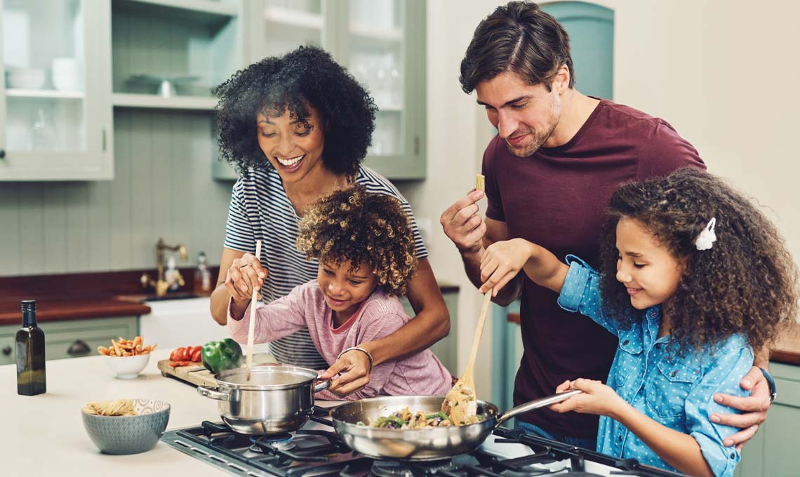 family around natural gas cooktop